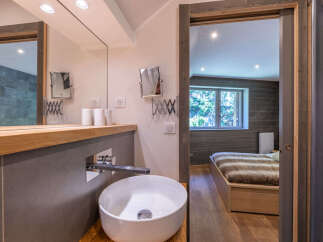 Experience modern comfort in this charming bathroom featuring a sleek vessel sink and a spacious vanity with ample counter space.