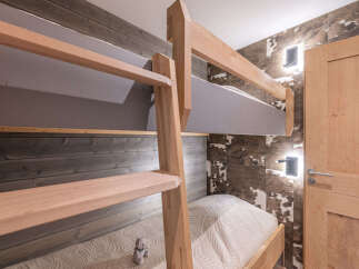 This charming bedroom features a cozy bunk bed setup, perfect for families or accommodating guests.