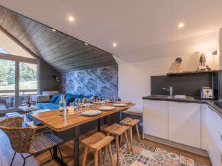 Experience modern living in this stylish apartment, featuring a spacious dining area perfect for gatherings and a sleek, fully-equipped kitchen.