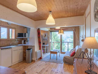 Experience cozy mountain living in this charming studio apartment, featuring a well-equipped kitchenette and a comfortable living area with stunning panoramic views.