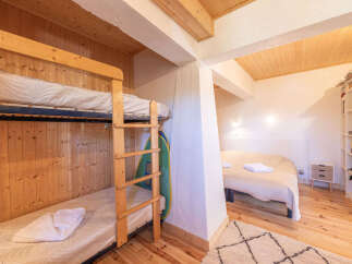 This charming room features a cozy bunk bed setup, perfect for families or groups.
