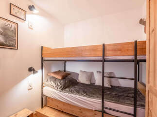 This cozy bedroom features a space-saving bunk bed, perfect for families or accommodating guests.