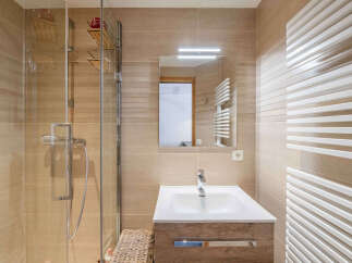 Experience modern comfort in this beautifully appointed bathroom, featuring a sleek glass-enclosed shower and a stylish vanity with ample storage.