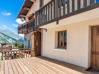 Experience breathtaking mountain views from this charming property featuring a spacious wooden deck perfect for outdoor entertaining.