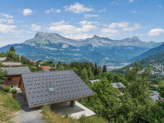 Experience breathtaking mountain views from this stunning property, nestled amidst lush greenery.