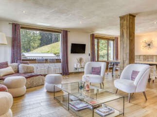 Experience luxurious mountain living in this stunning living room, featuring plush seating and a cozy fireplace.