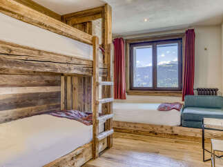 Experience rustic charm in this mountain-view bedroom, featuring a sturdy wooden bunk bed perfect for families or groups.