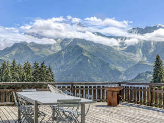Enjoy breathtaking mountain views from this stunning balcony, perfect for outdoor dining and relaxation.
