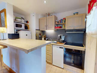 Discover this charming kitchen featuring a breakfast bar with ample counter space, perfect for casual dining or entertaining.