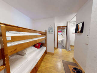 This charming room features a space-saving bunk bed, perfect for families or groups.