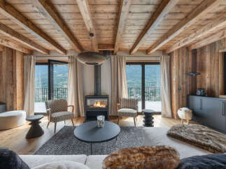 Experience luxurious mountain living in this stunning living room, featuring a cozy fireplace and breathtaking panoramic views.