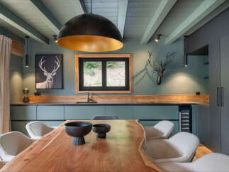 Experience rustic elegance in this modern kitchen, featuring a stunning live-edge dining table as the centerpiece.