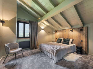 Experience rustic charm and modern comfort in this mountain retreat bedroom.