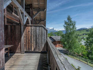 Experience breathtaking mountain views from this charming wooden balcony, perfect for enjoying your morning coffee or evening relaxation.