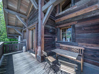Experience rustic charm on this wooden balcony, perfect for enjoying the mountain air.