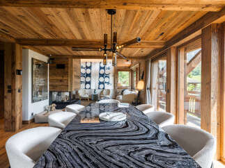 Experience luxurious mountain living in this stunning dining room, featuring a dramatic black and white marble dining table as the centerpiece.