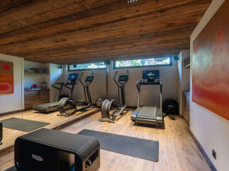 Elevate your wellness routine in this dedicated home gym, featuring state-of-the-art treadmills and elliptical machines.