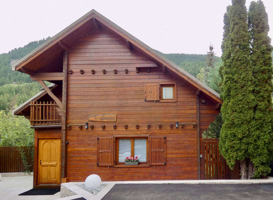 Charming wooden chalet nestled amidst lush greenery, perfect for a serene mountain getaway.