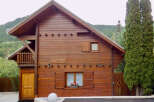 Charming wooden chalet nestled amidst lush greenery, perfect for a serene mountain getaway.