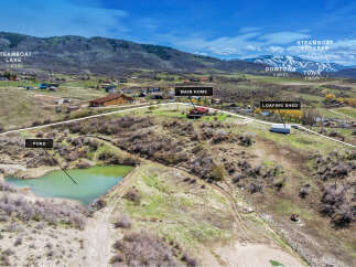Discover your dream mountain retreat with this stunning property offering a serene pond and a charming main home.