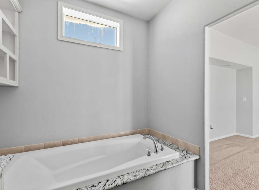 Indulge in relaxation in this luxurious bathroom featuring a deep soaking tub, perfect for unwinding after a long day.