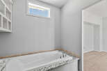 Indulge in relaxation in this luxurious bathroom featuring a deep soaking tub, perfect for unwinding after a long day.