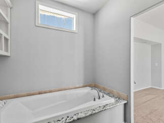 Indulge in relaxation in this luxurious bathroom featuring a deep soaking tub, perfect for unwinding after a long day.