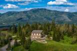 Nestled amidst a lush forest with a majestic mountain backdrop, this property offers a serene retreat.