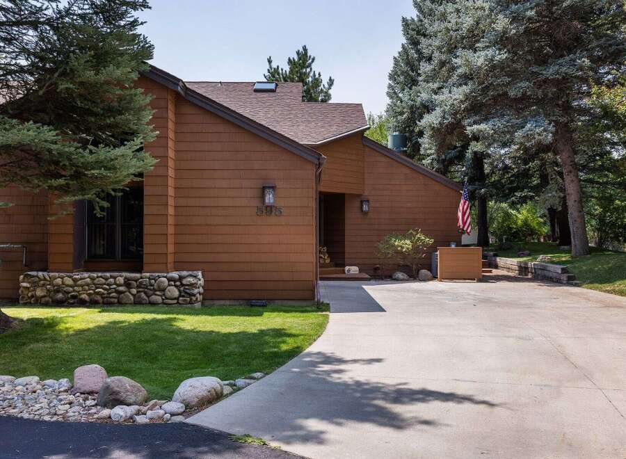 Discover this charming home featuring a warm brown exterior and a welcoming entrance.