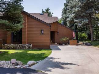 Discover this charming home featuring a warm brown exterior and a welcoming entrance.