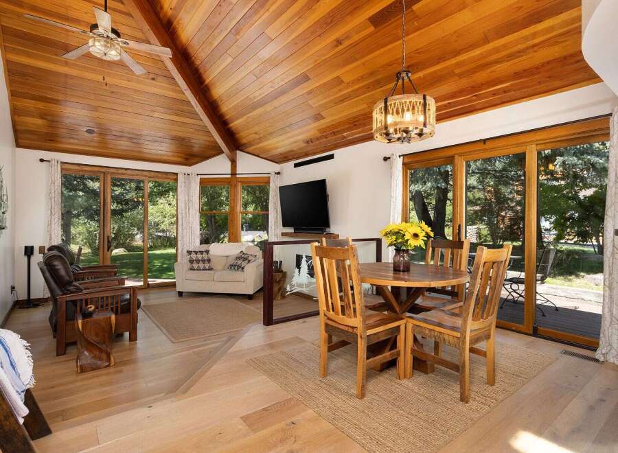 Experience rustic charm and modern comfort in this inviting living and dining area.