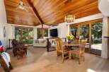 Experience rustic charm and modern comfort in this inviting living and dining area.