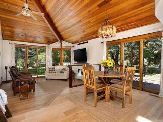 Experience rustic charm and modern comfort in this inviting living and dining area.