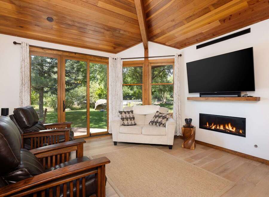 Experience ultimate relaxation in this inviting living room, featuring plush leather armchairs and a cozy loveseat perfect for gathering.