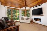 Experience ultimate relaxation in this inviting living room, featuring plush leather armchairs and a cozy loveseat perfect for gathering.