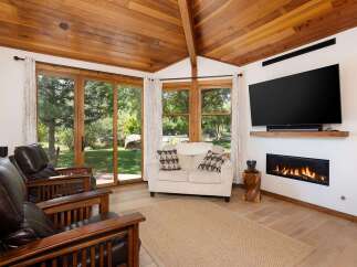 Experience ultimate relaxation in this inviting living room, featuring plush leather armchairs and a cozy loveseat perfect for gathering.