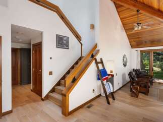 Discover this charming home featuring a beautiful wooden staircase leading to the upper level.