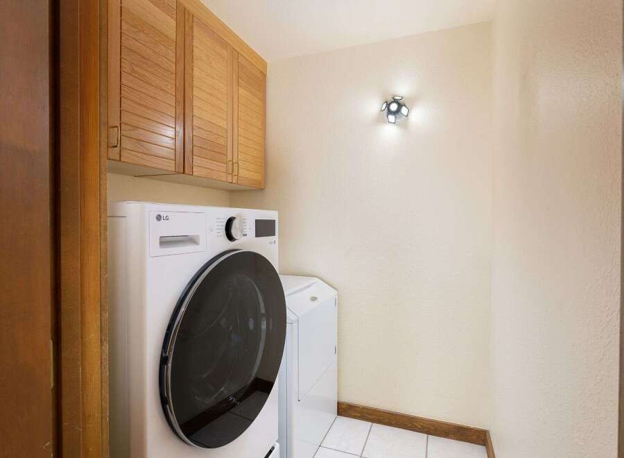 This laundry room features a stacked LG washer and dryer set, perfect for maximizing space.