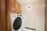 This laundry room features a stacked LG washer and dryer set, perfect for maximizing space.