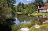 Experience serene living with this stunning property featuring a tranquil pond and lush greenery, perfect for relaxation and outdoor enjoyment.