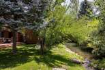 Enjoy serene outdoor living with this charming property featuring a spacious deck overlooking a tranquil creek.