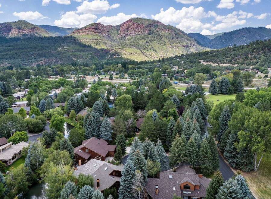 Nestled amidst lush greenery and mature trees, this property offers a serene mountain retreat.