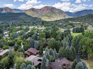 Nestled amidst lush greenery and mature trees, this property offers a serene mountain retreat.