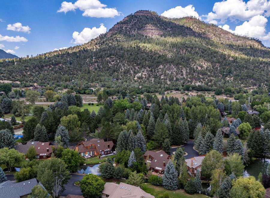 Nestled amidst a lush forest and overlooking a majestic mountain, this property offers a serene and private retreat.