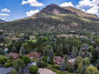 Nestled amidst a lush forest and overlooking a majestic mountain, this property offers a serene and private retreat.