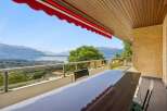 Enjoy breathtaking panoramic views of the lake and mountains from this stunning balcony.