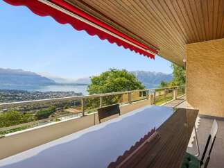Enjoy breathtaking panoramic views of the lake and mountains from this stunning balcony.