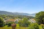 Experience breathtaking panoramic views of the lake and mountains from this stunning property.
