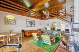 Experience mid-century modern living in this stunning home featuring a dramatic vaulted wood-beamed ceiling and an open loft space.
