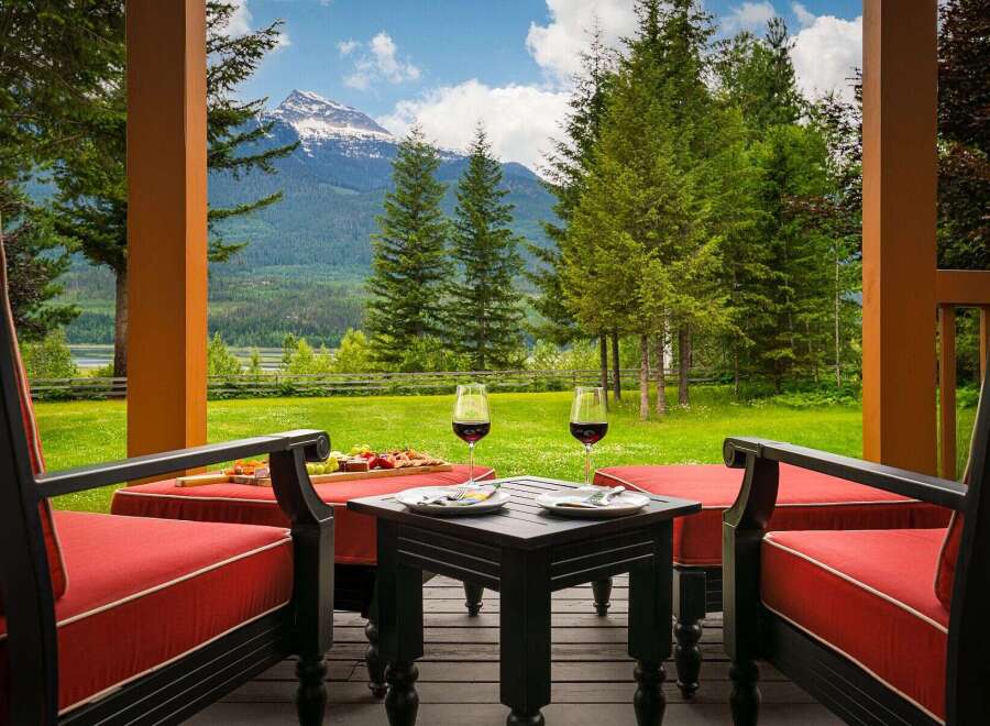 Experience breathtaking mountain views from this stunning property's covered porch, perfect for enjoying a glass of wine.